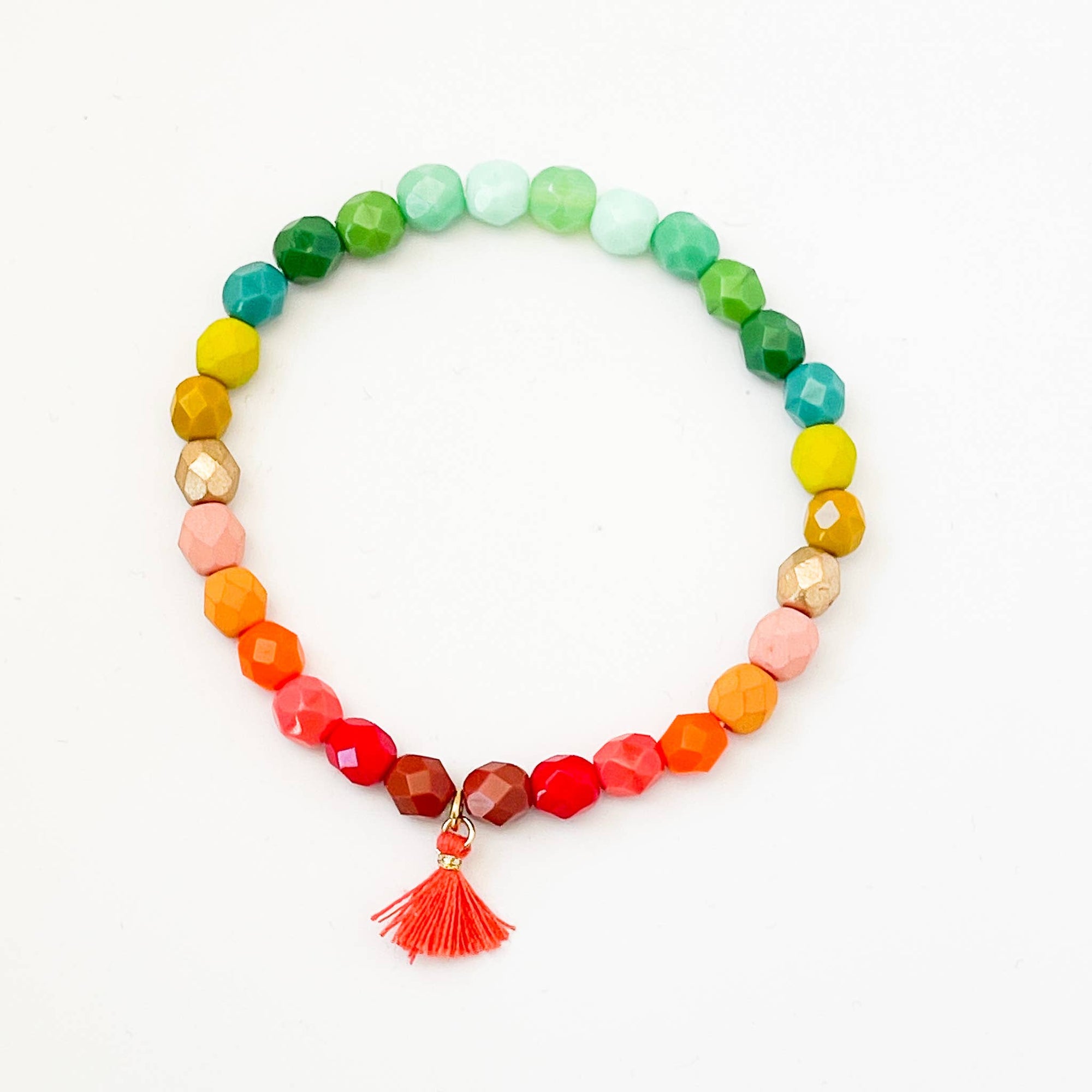 Colorful beaded bracelet with a tassel on a white background