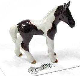 Small model horse with a white and brown pattern on a white background