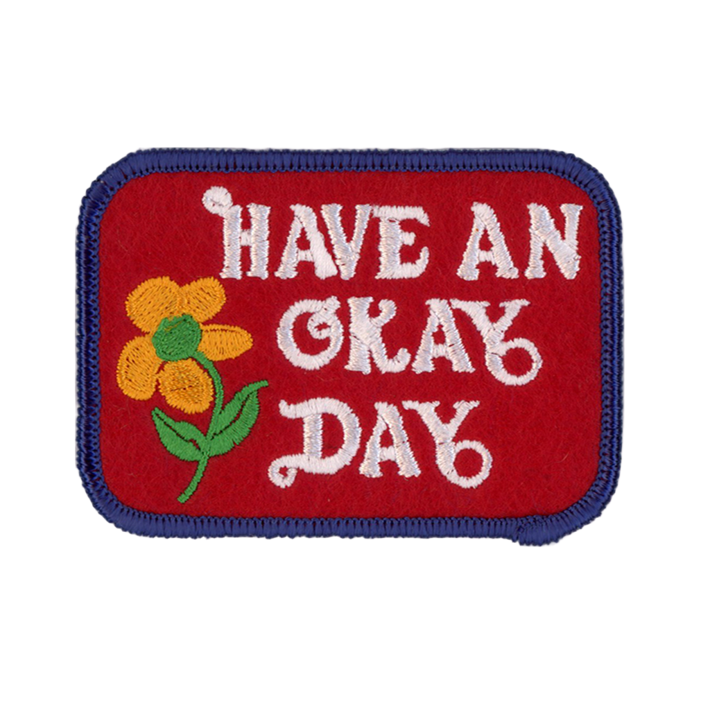 Embroidered patch with 'Have an Okay Day' text and a flower on a red background