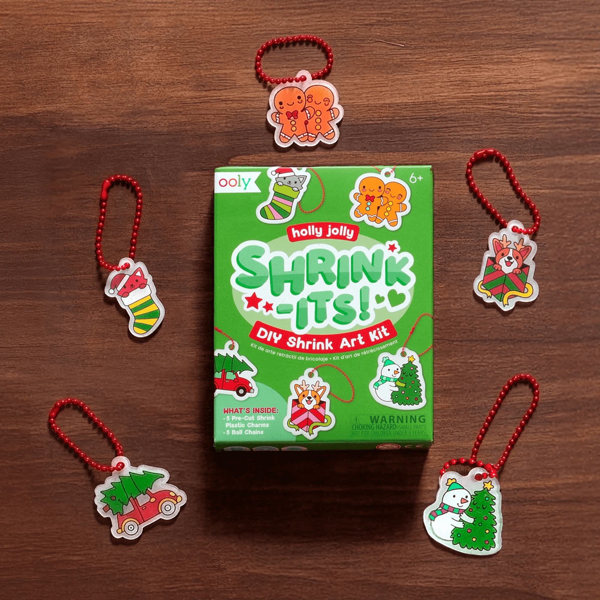Shrinky Dinks art kit packaging with shrinked toys on a wooden surface