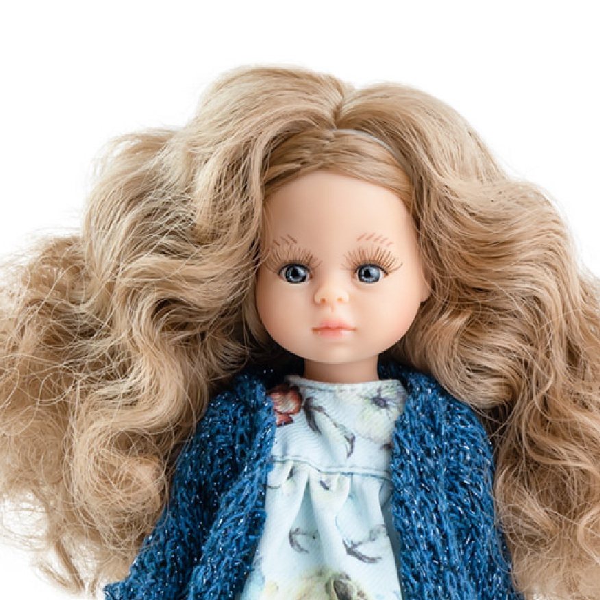 Doll with long blonde hair wearing a blue knitted cardigan and floral dress on a white background