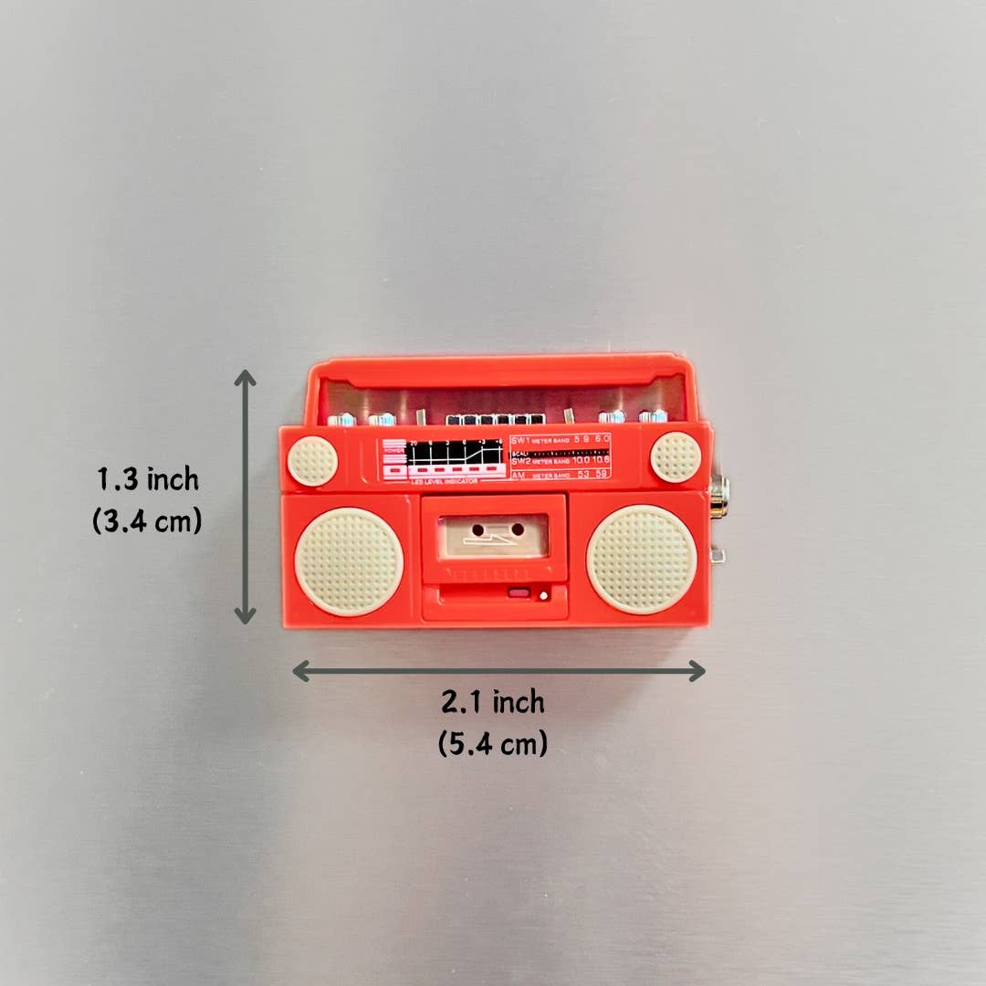 Red toy radio with measurements on a gray background