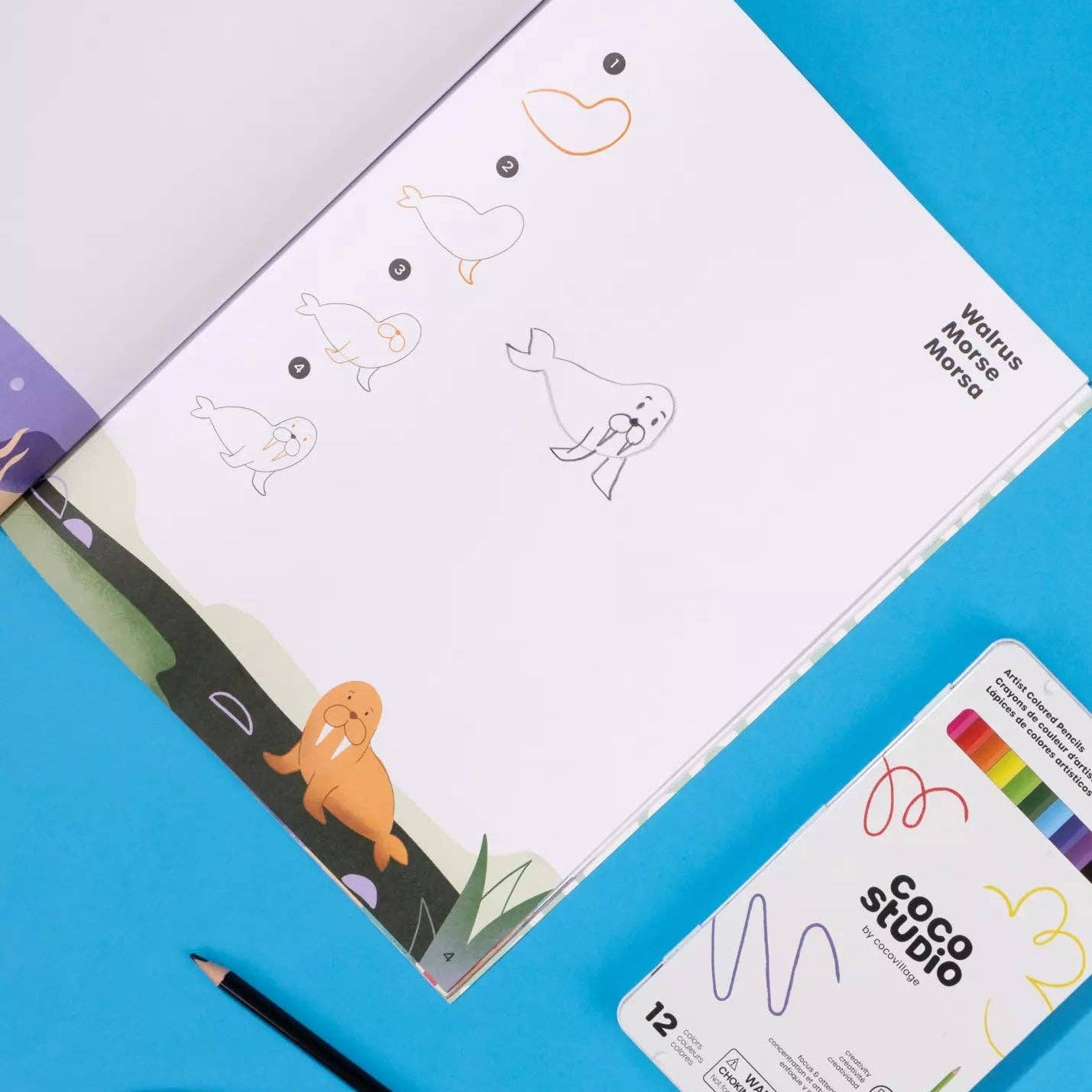 Children's activity book with coloring pages and pencils on a blue background
