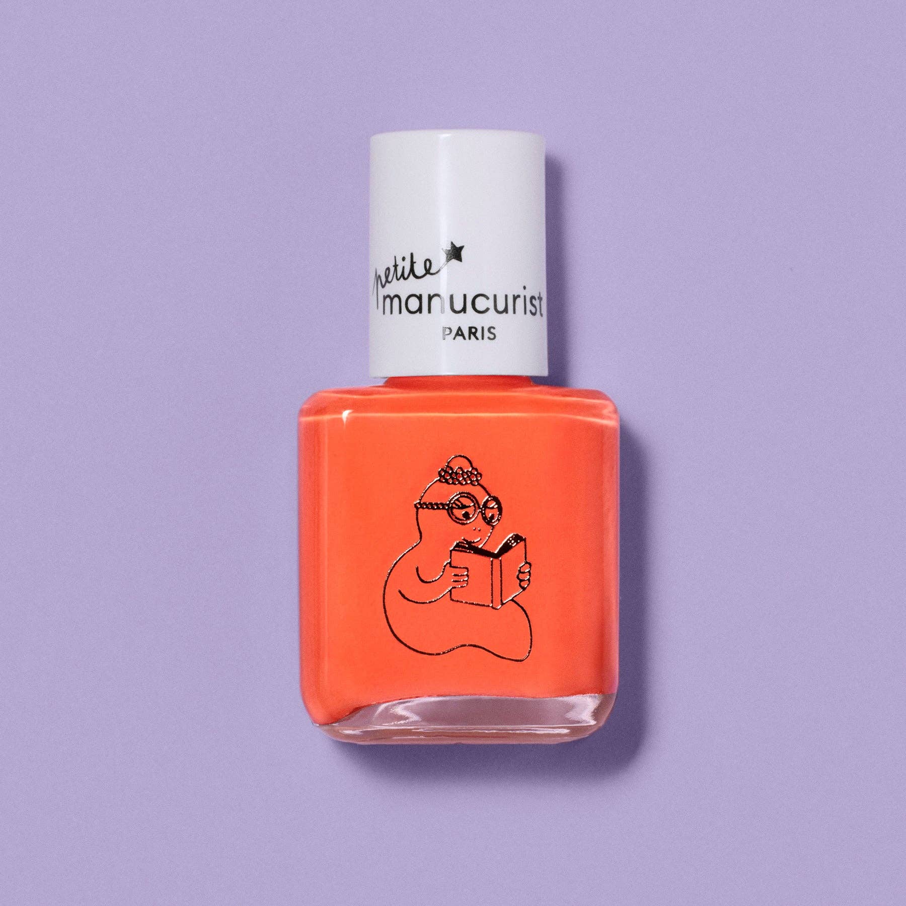 Orange nail polish bottle with 'petite manucurist' label on a purple background