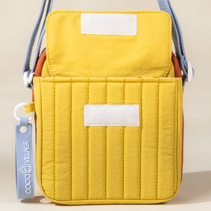 Yellow quilted bag with a visible brand tag on a beige background
