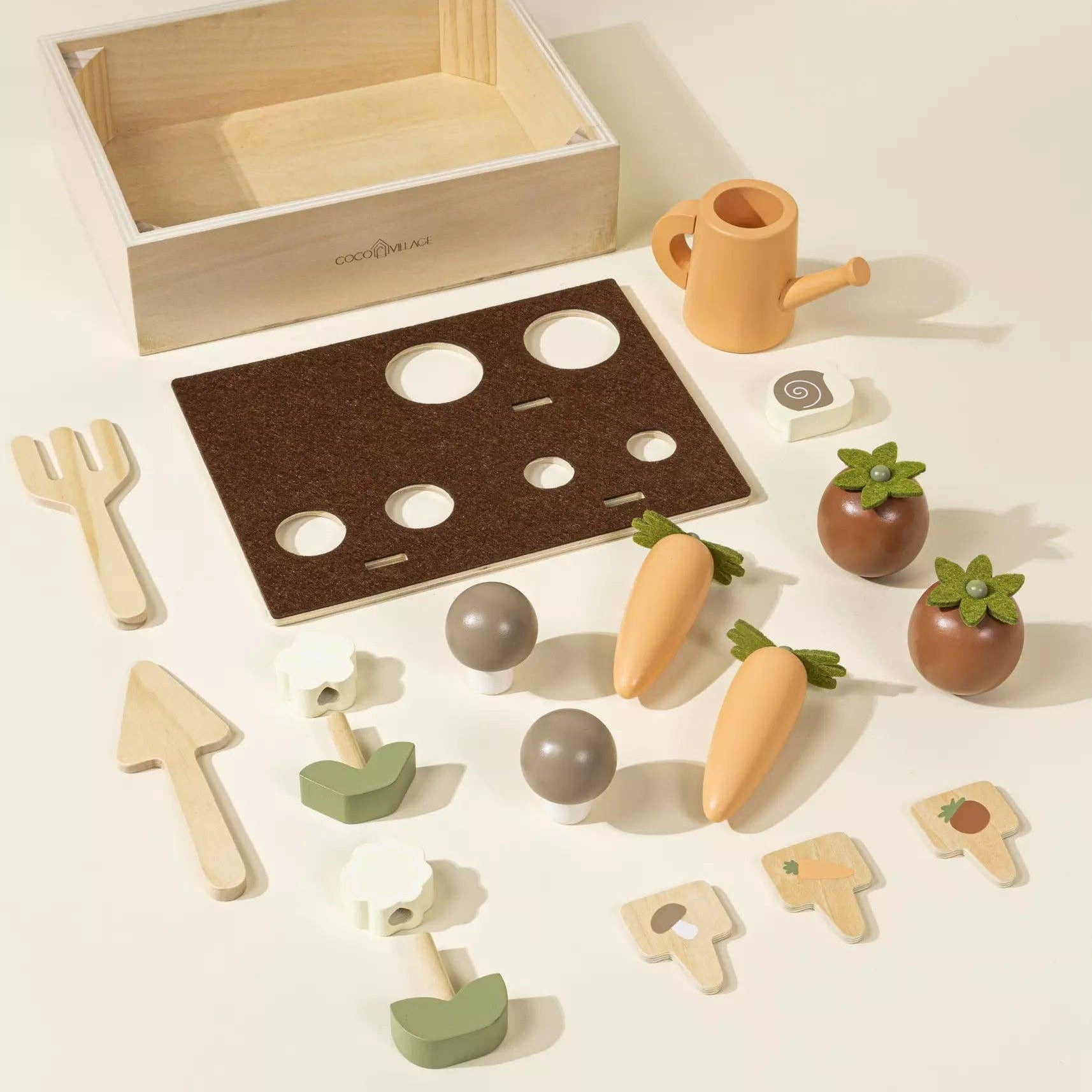 Wooden gardening set with tools and plants on a light background