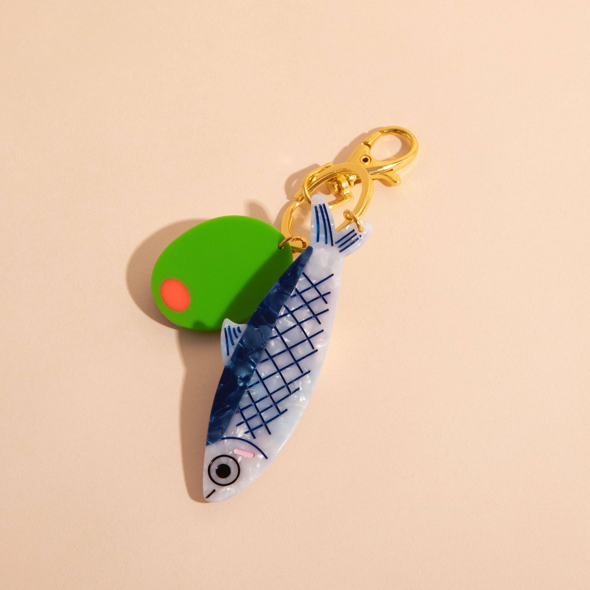 Keychain with fish design on a beige background