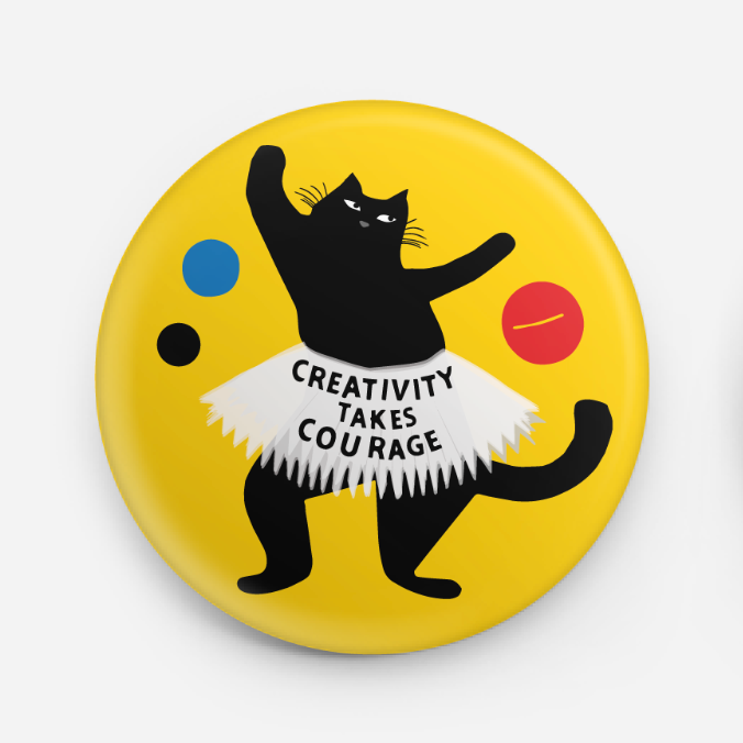 Button badge with a black cat illustration and 'Creativity Takes Courage' text on a yellow background