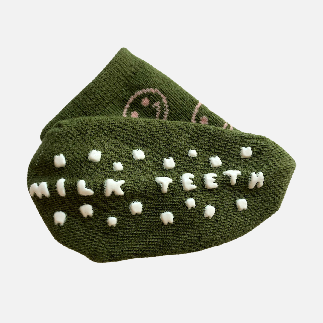 Green socks with white text and patterns on a light gray background
