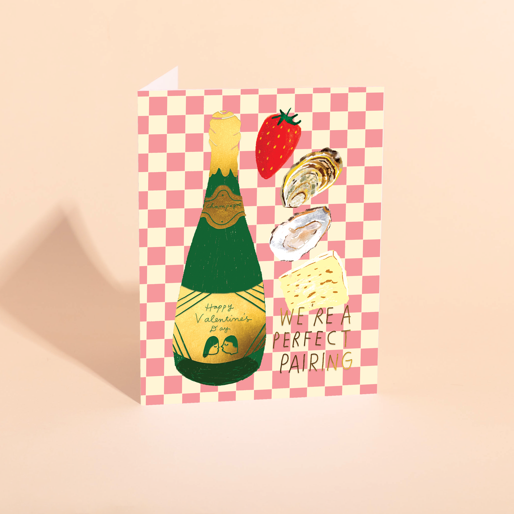 Valentine's Day card with champagne bottle, food illustrations, and 'We're a Perfect Pairing' text on a checkered background.