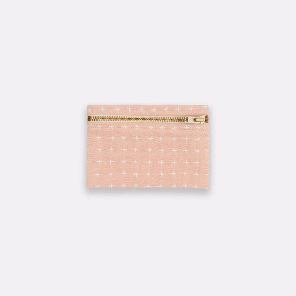 Pink pouch with gold zipper on a white background