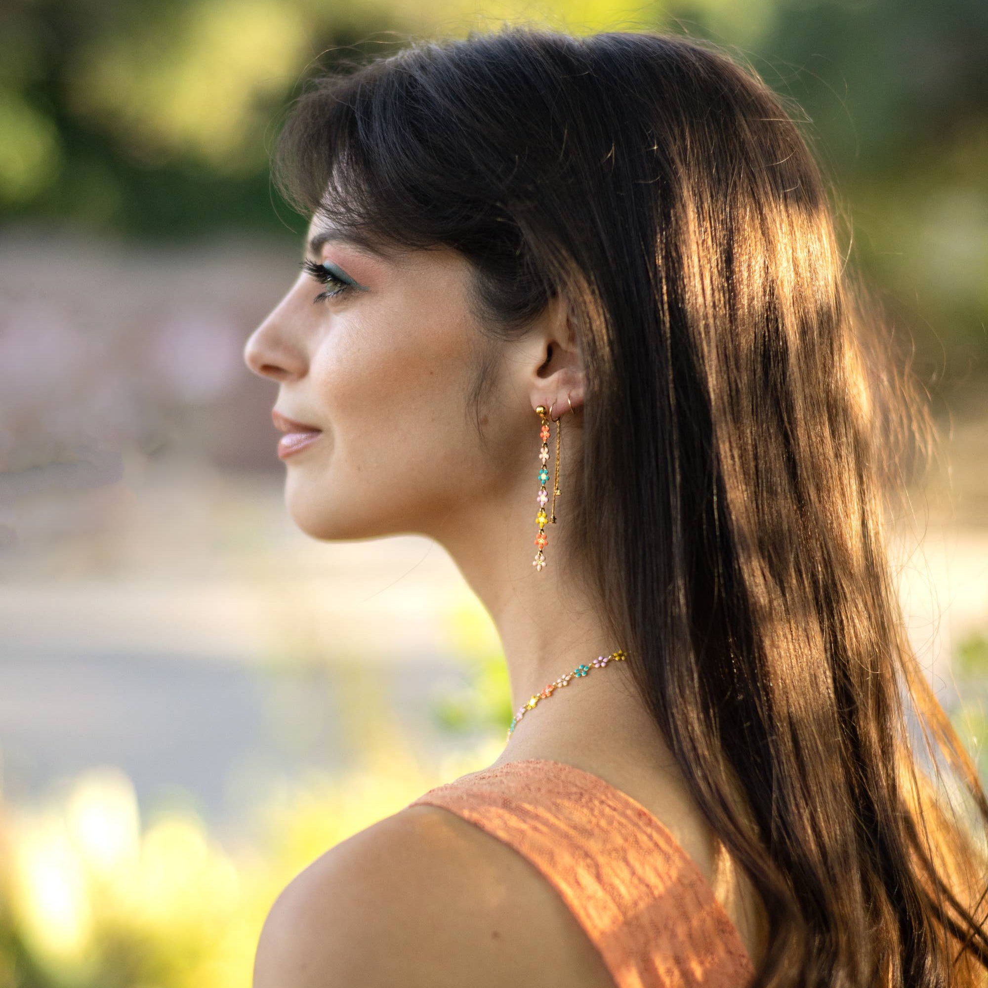 Woman with long hair and a blurred outdoor background
