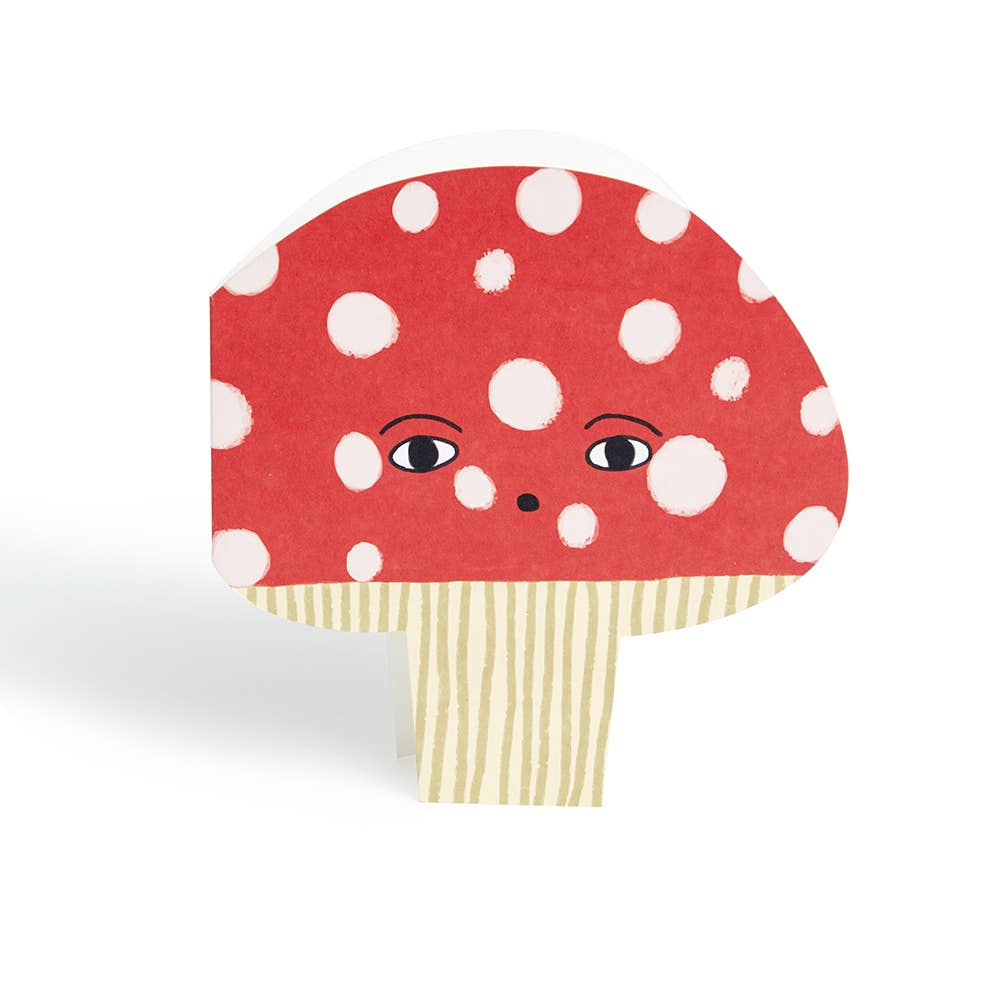 Mushroom-shaped object with a red cap and white spots on a white background
