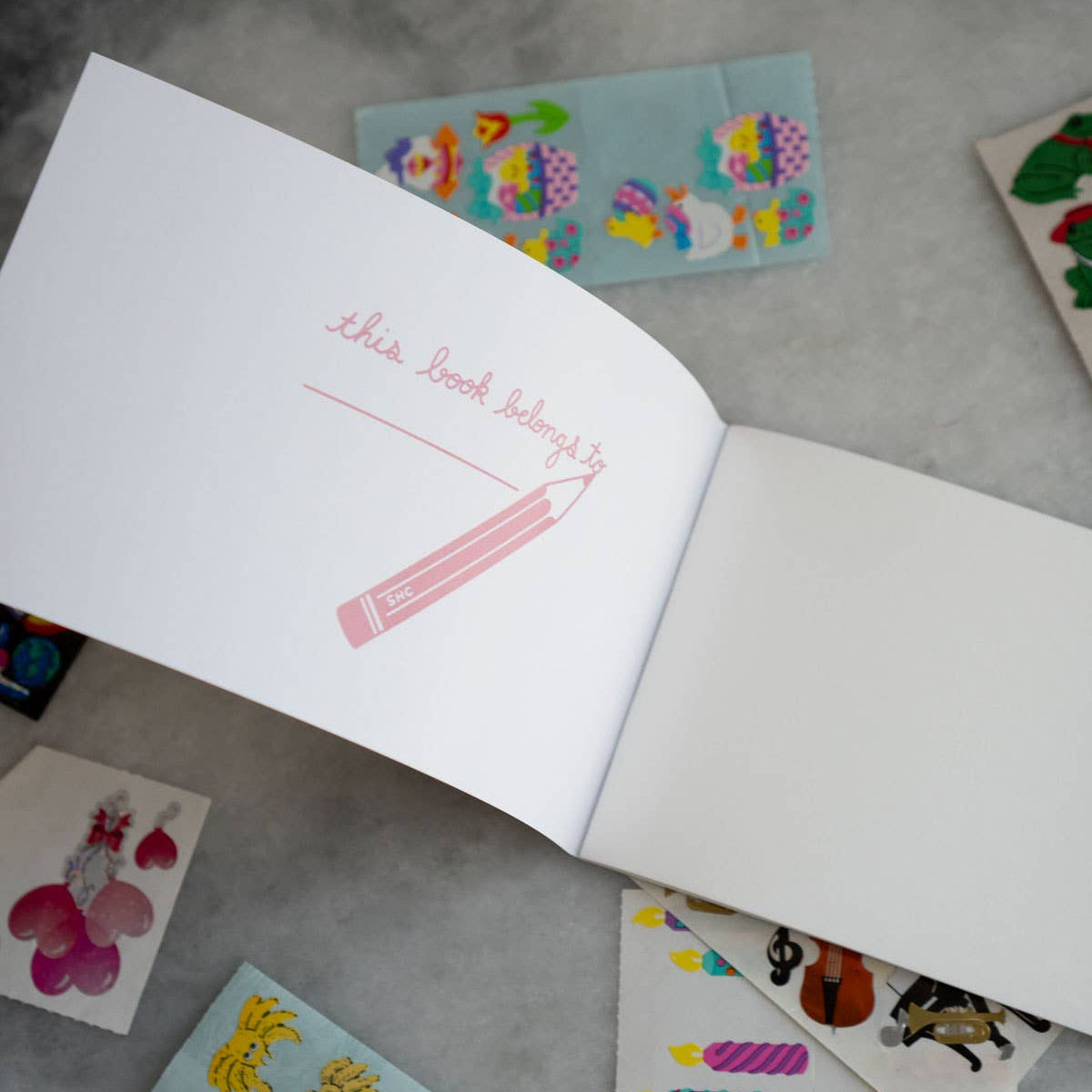 Open book with illustrations on a gray surface