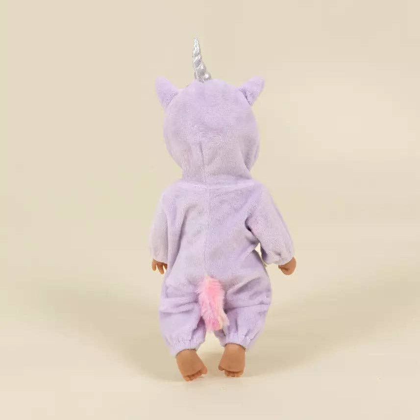 A plush unicorn costume or doll viewed from the back, featuring a light purple hooded body, a silver horn, and a pink tail, standing against a plain beige studio background.