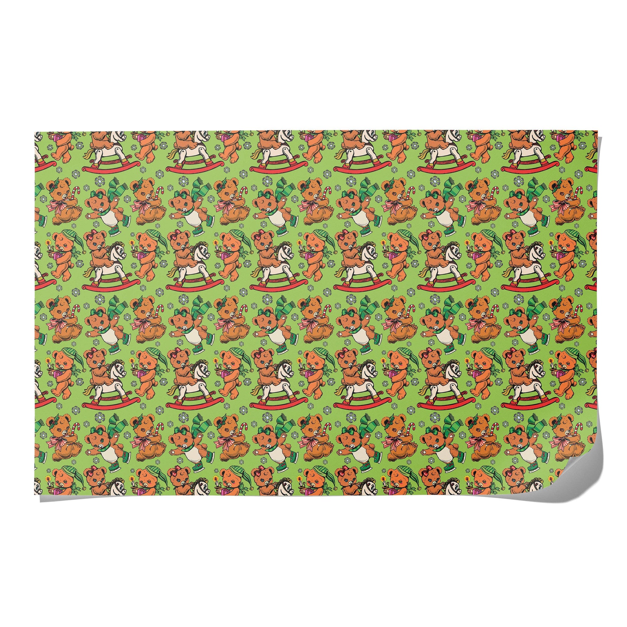 Patterned sheet on a green background with teddy bears and rocking horses.