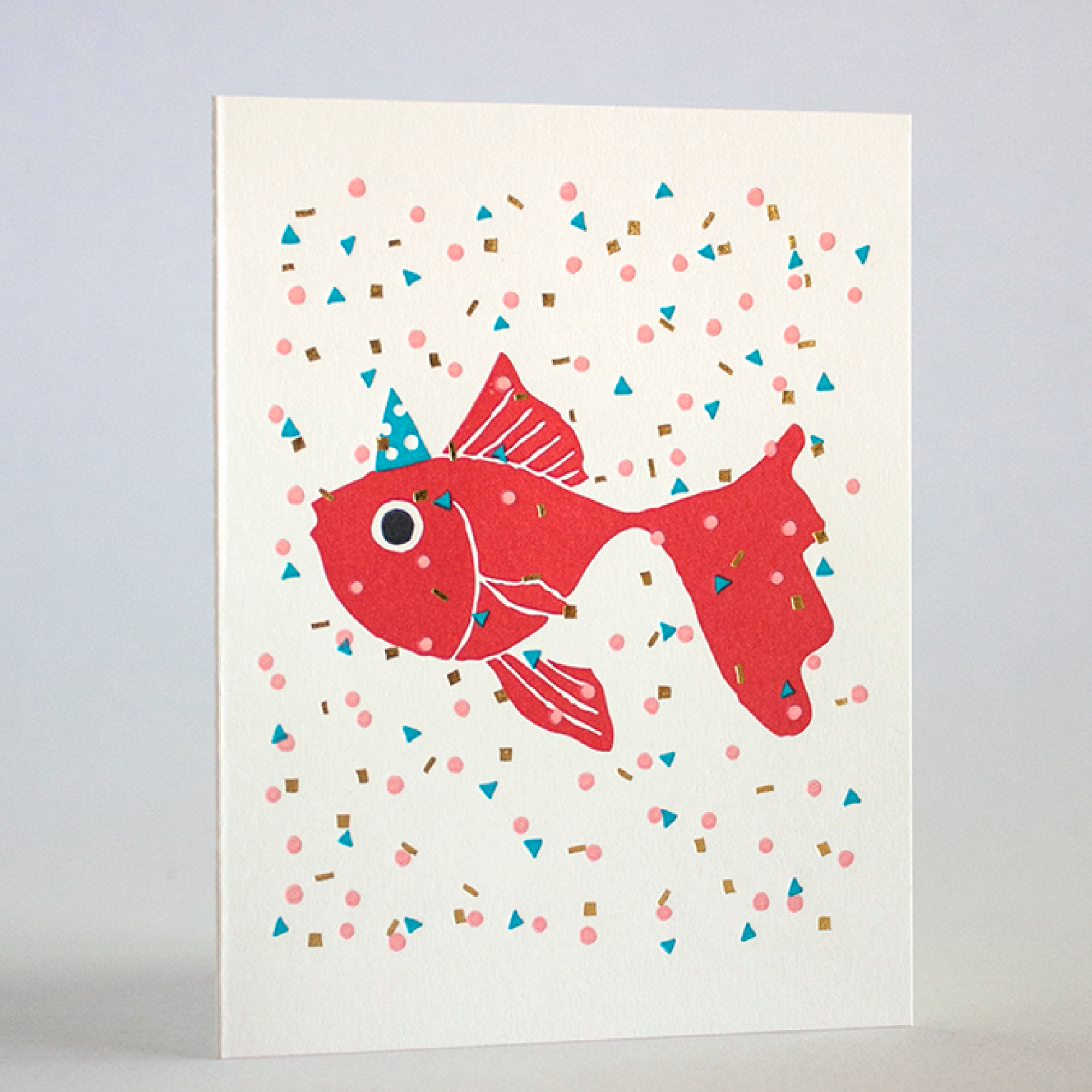 Letterpress printed card with a red fish illustration on a white background