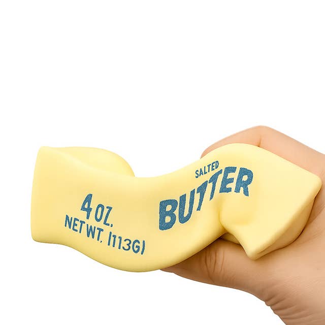 Hand holding a yellow block labeled 'Salted Butter' with text indicating weight.
