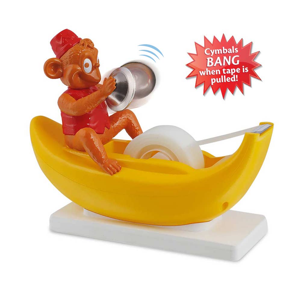 Toy monkey in a banana boat with cymbals and tape, on a white background