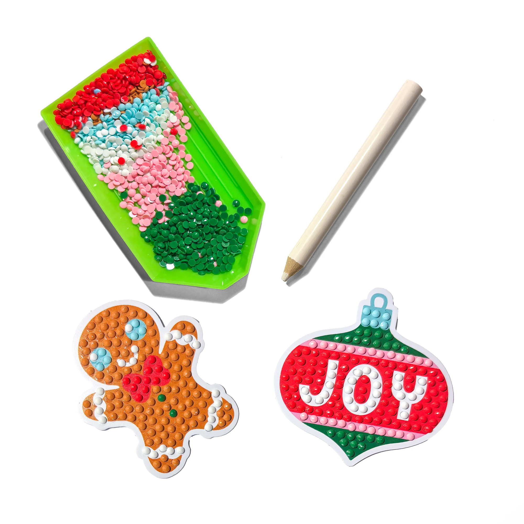DIY craft kit with beads, tools, and partially completed Christmas-themed items on a white background