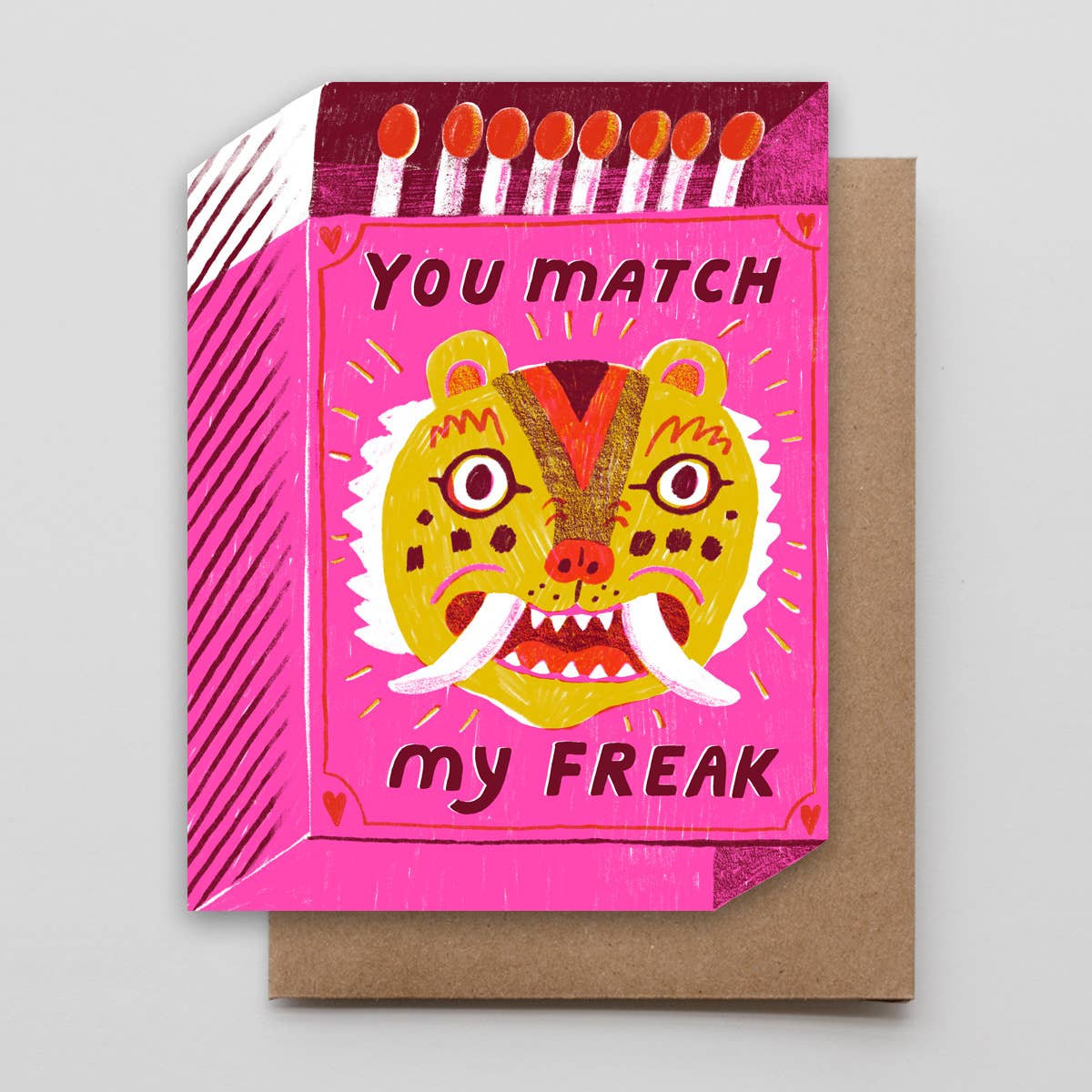 Greeting card with a colorful design of a tiger face and text on a pink background