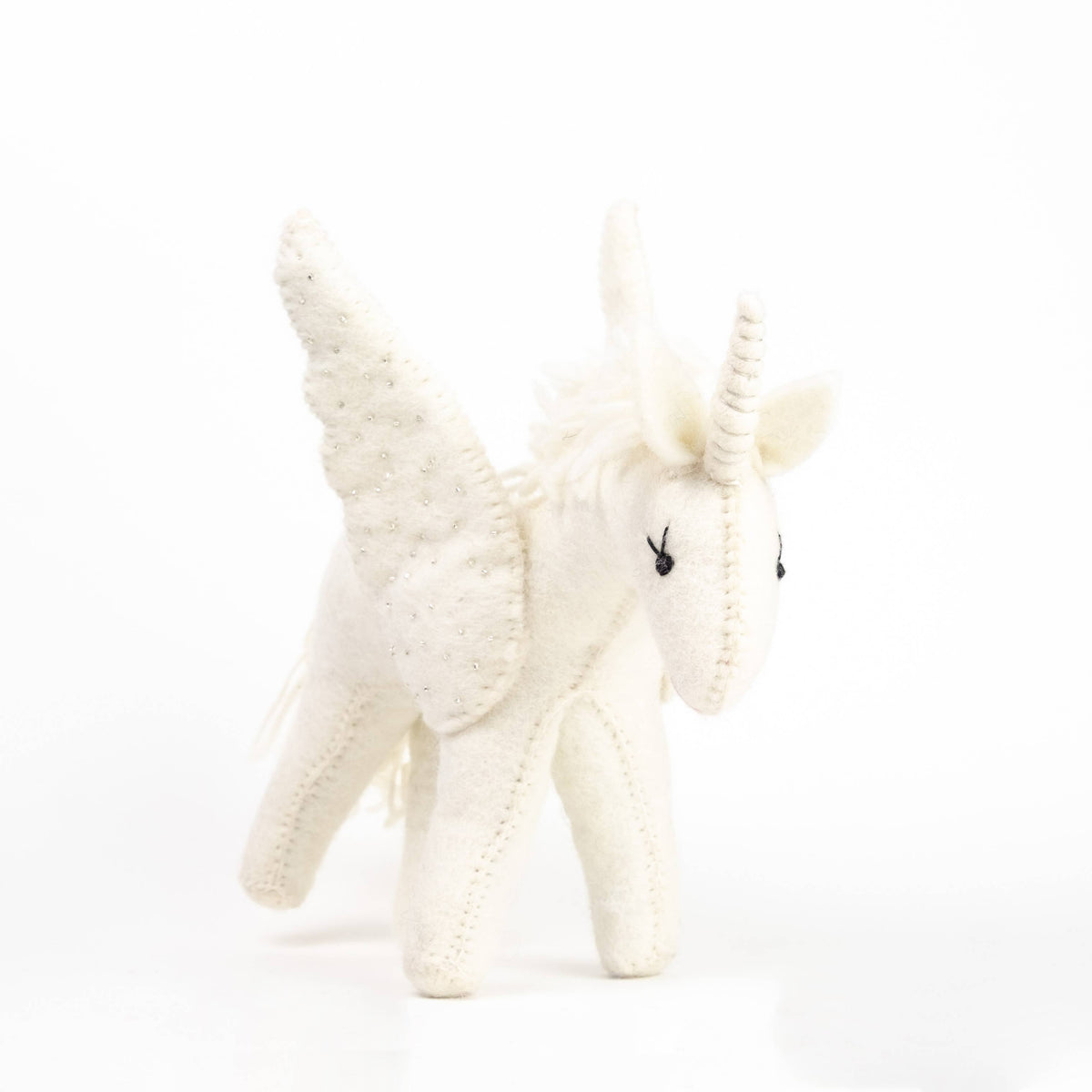 White unicorn plush toy on a white background