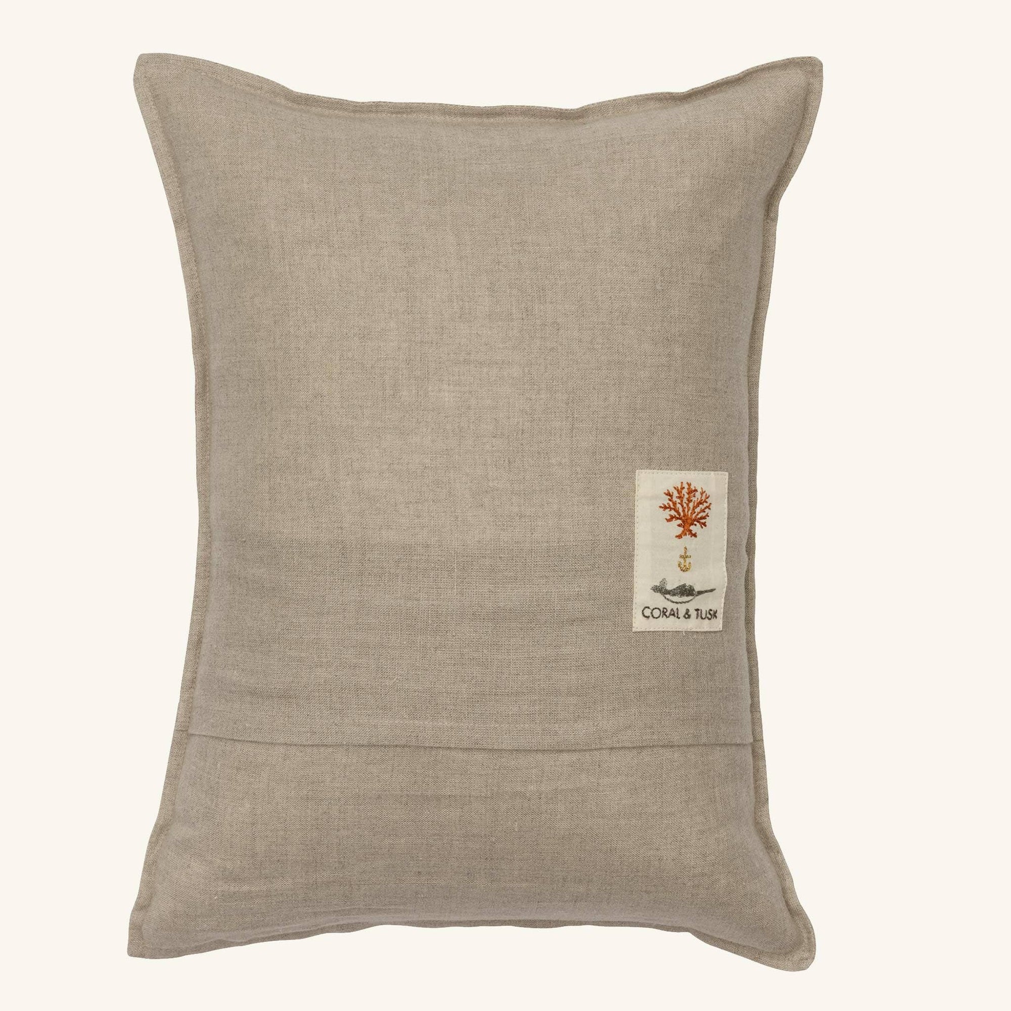 Beige pillow with a small logo on a white background