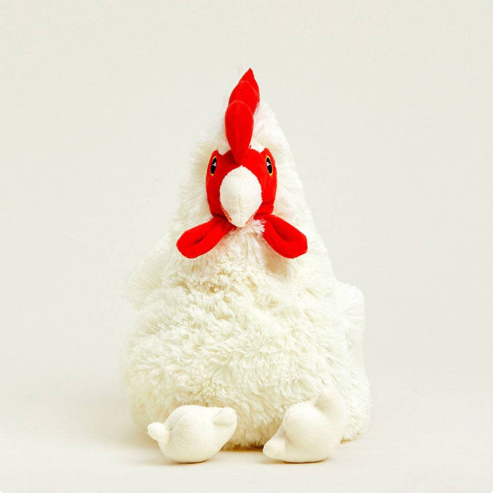 A plush toy chicken with fluffy white fur, a bright red comb, and a white beak, sitting against a plain light gray background.