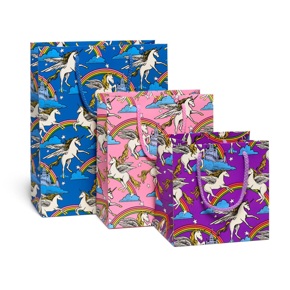 Set of three colorful gift bags with unicorn and rainbow designs on a white background