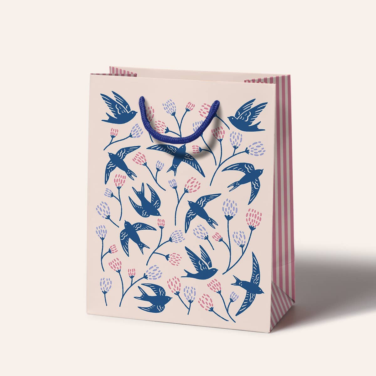 Gift bag with blue bird and flower pattern on a white background