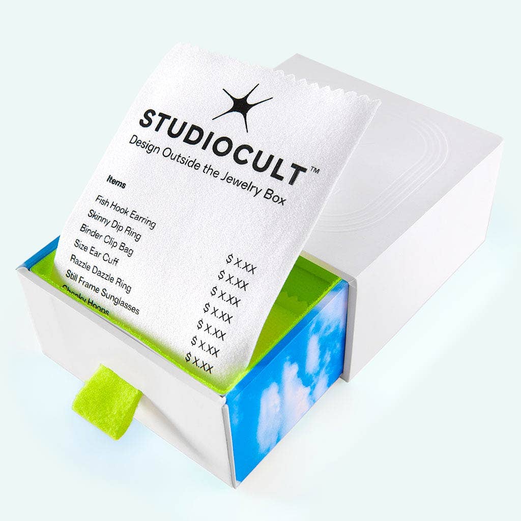Studiocult jewelry box with product list on a light blue background