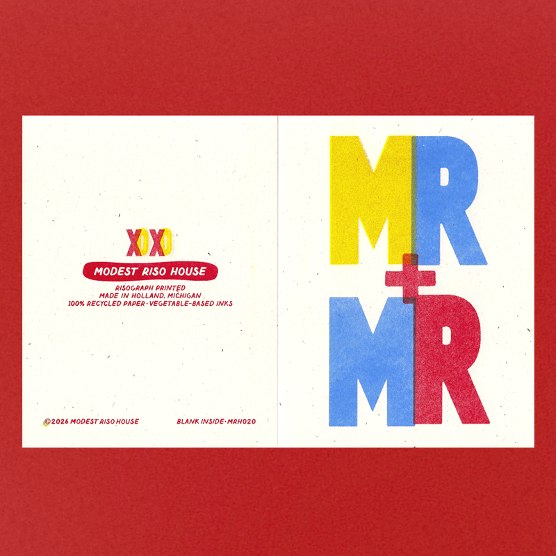 An open greeting card or art print with a white interior, featuring large colorful 'MR + MR' lettering in yellow, blue, and red on the right, and small printed text on the left, set against a solid red background.