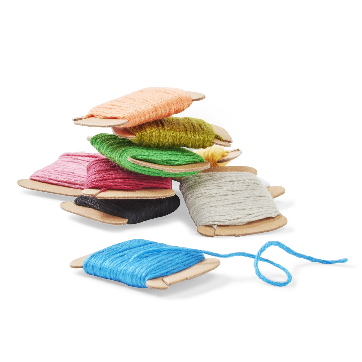 A stack of colorful yarn skeins wound on small wooden spools, with one blue skein in front on a white background.