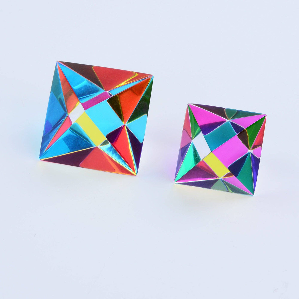 Multicolored geometric earrings on a light blue background