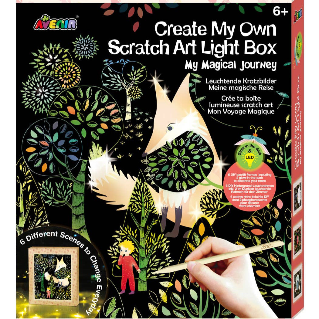 A box of the 'Create My Own Scratch Art Light Box - My Magical Journey' kit, showing illustrations of animals, plants, and a young girl creating scratch art. The box indicates this is suitable for children aged 6 and up.