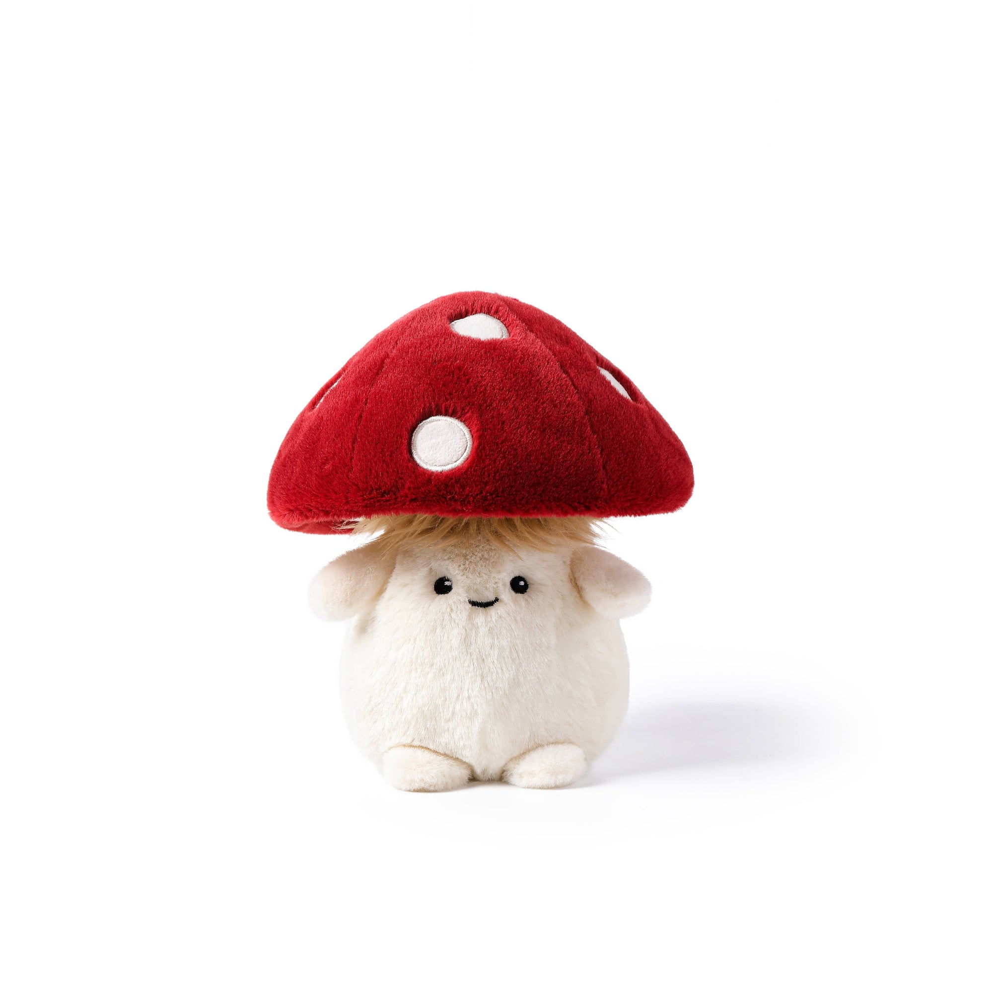 Small plush toy with a red mushroom hat on a white background