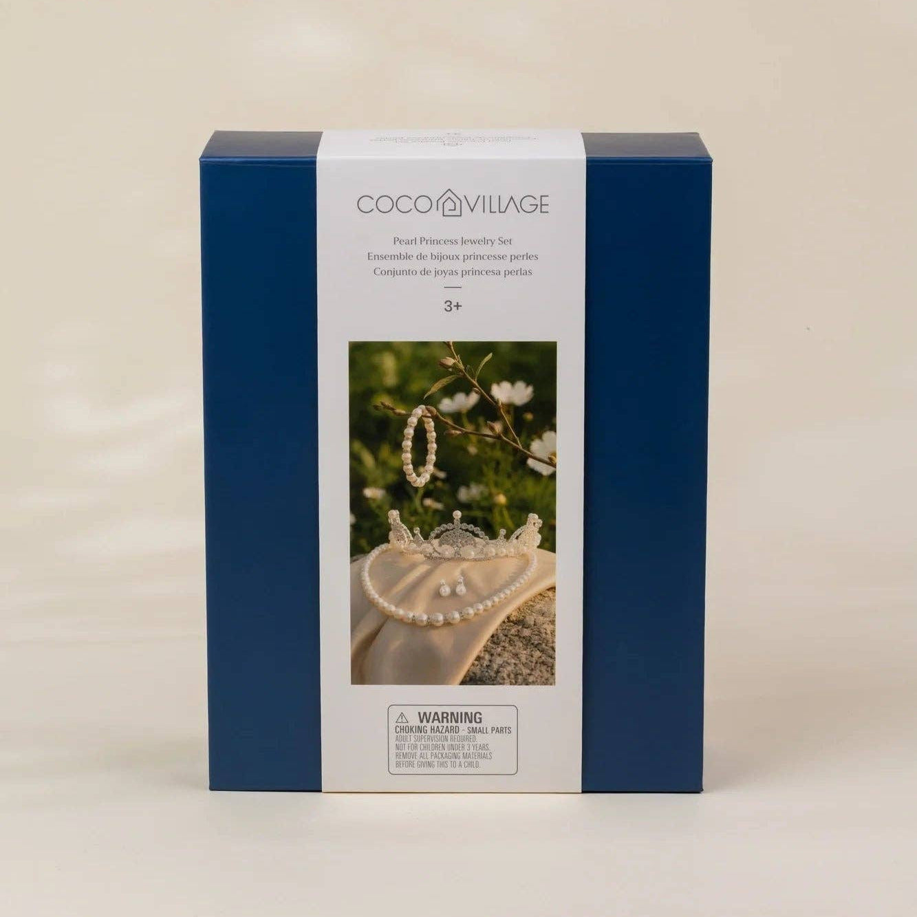 A square blue and white product box for Coco Village bead jewelry kits, featuring a photo of a pearl heart and jewelry on the front, set against a plain beige background.