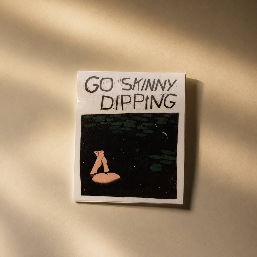 Decorative sticker with 'Go Skinny Dipping' text and illustration on a beige background