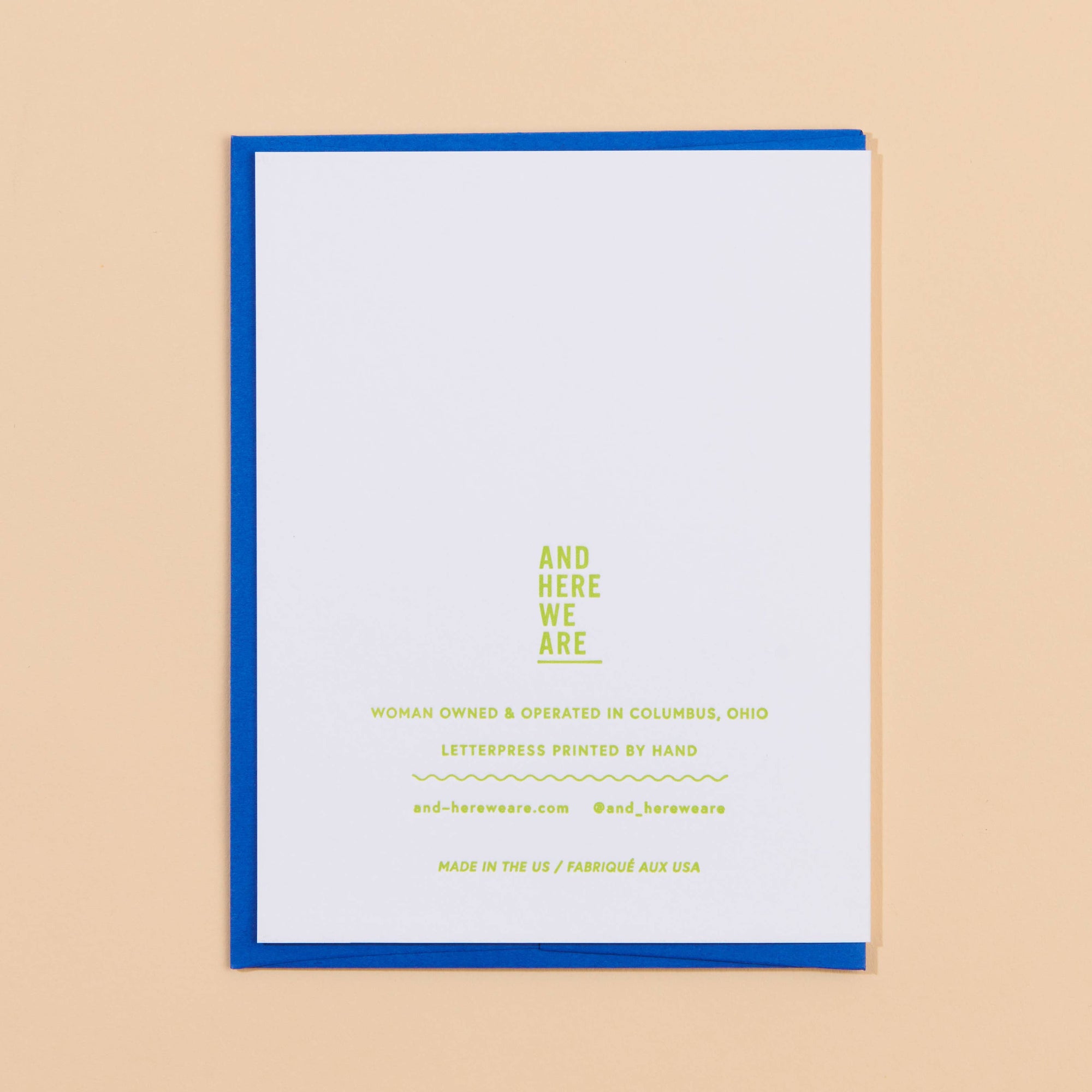 White card with blue border and yellow text on a beige background