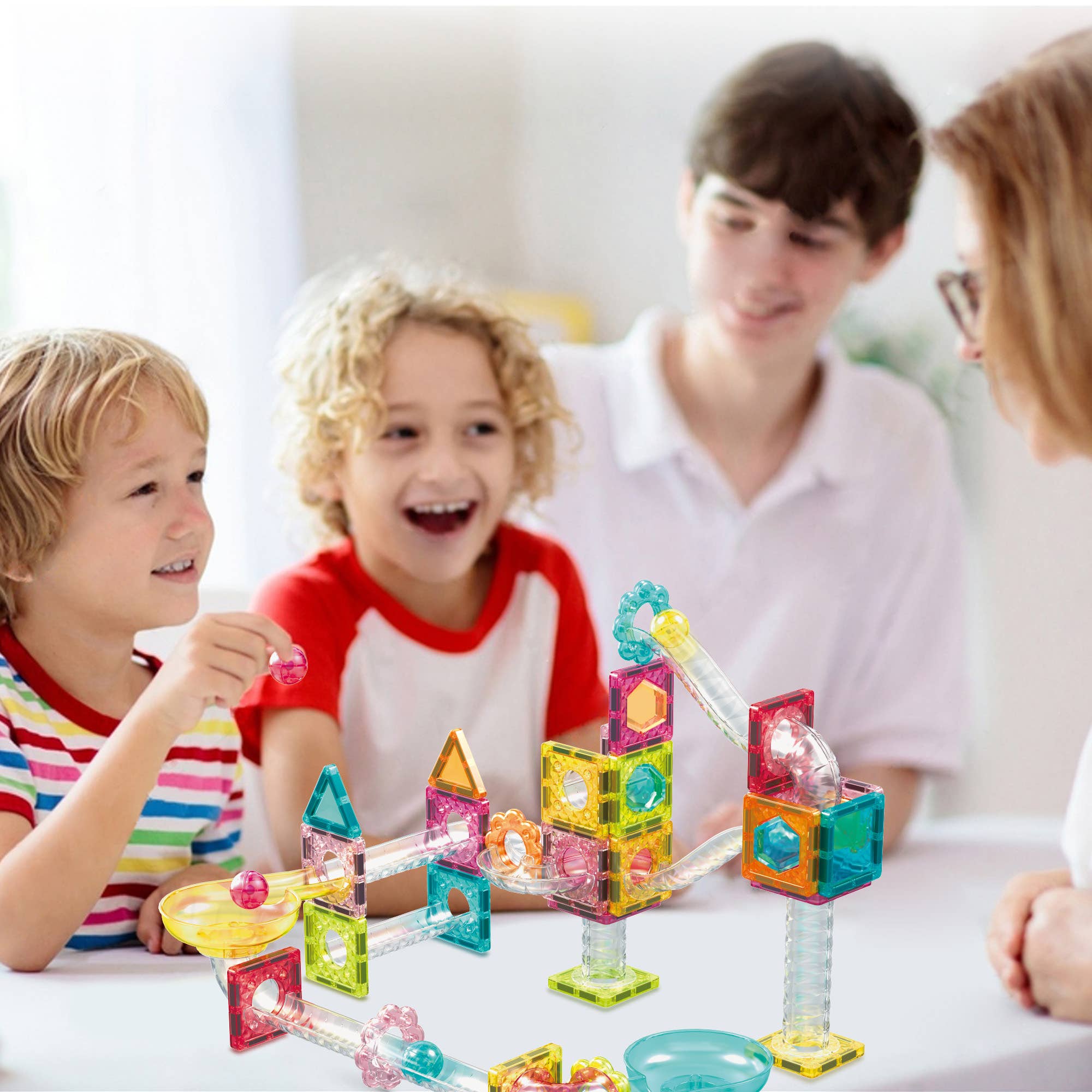 Children playing with colorful building blocks at a table
