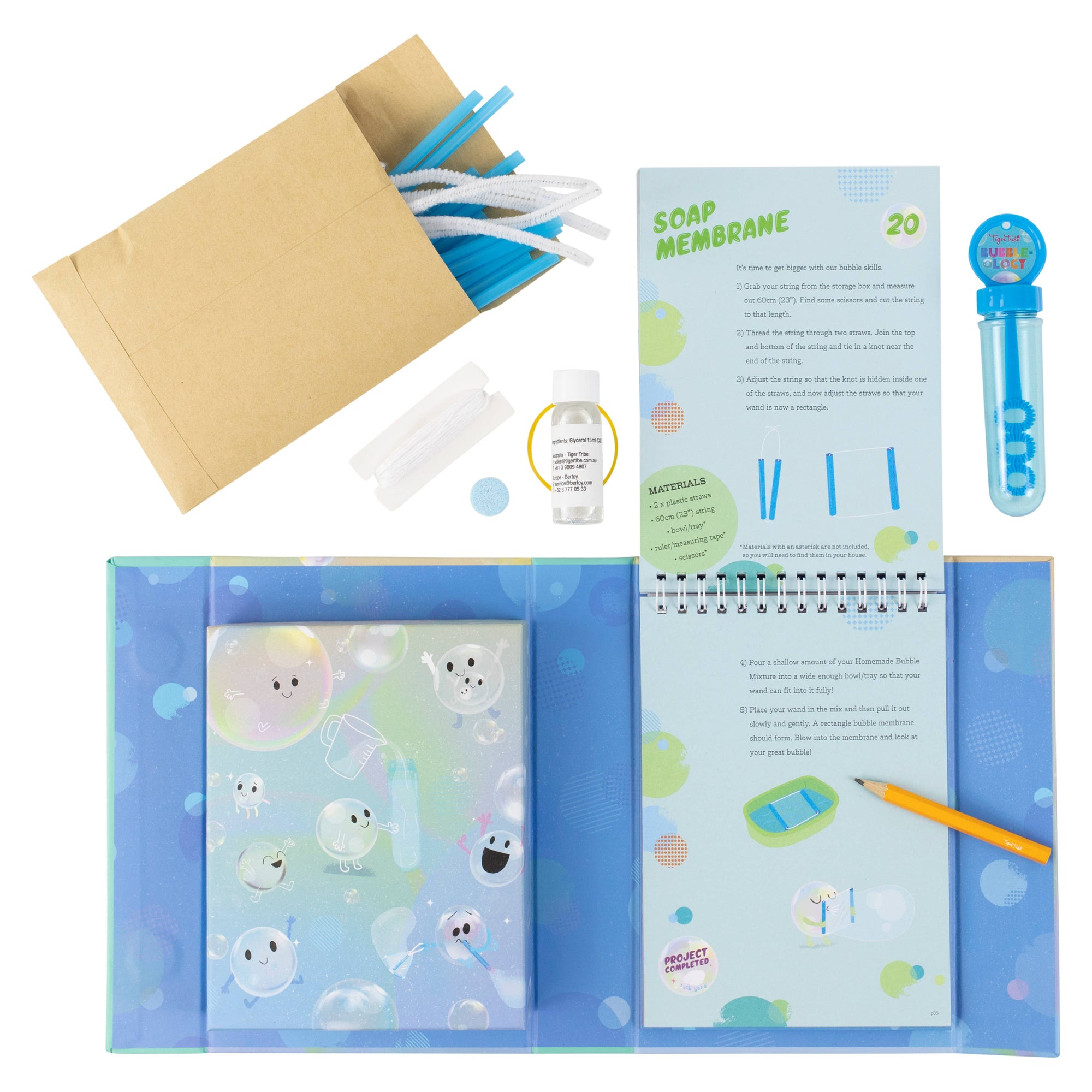Science experiment kit with materials and a notebook on a white background