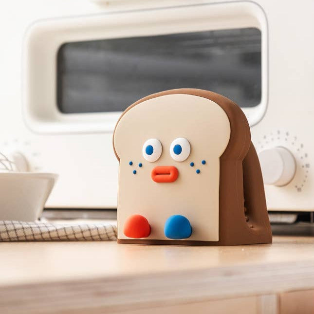 Toast oven mitt with a face on a kitchen counter