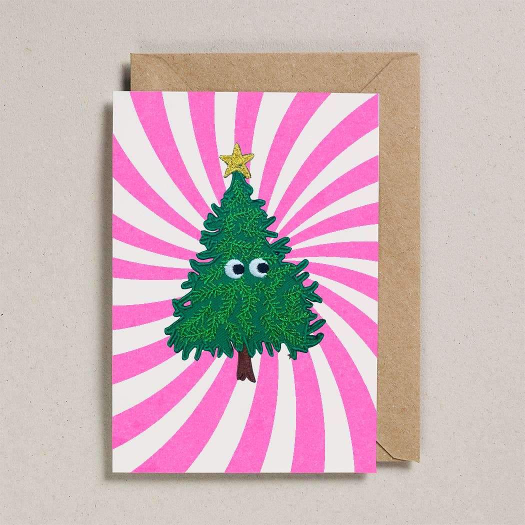 Greeting card with a cartoon Christmas tree on a pink and white striped background