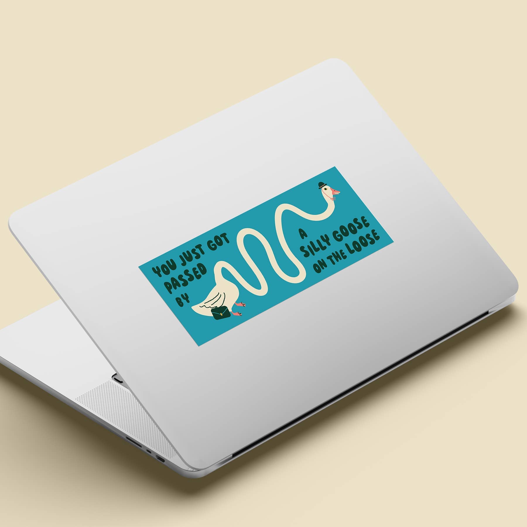 Laptop with a sticker on a beige background