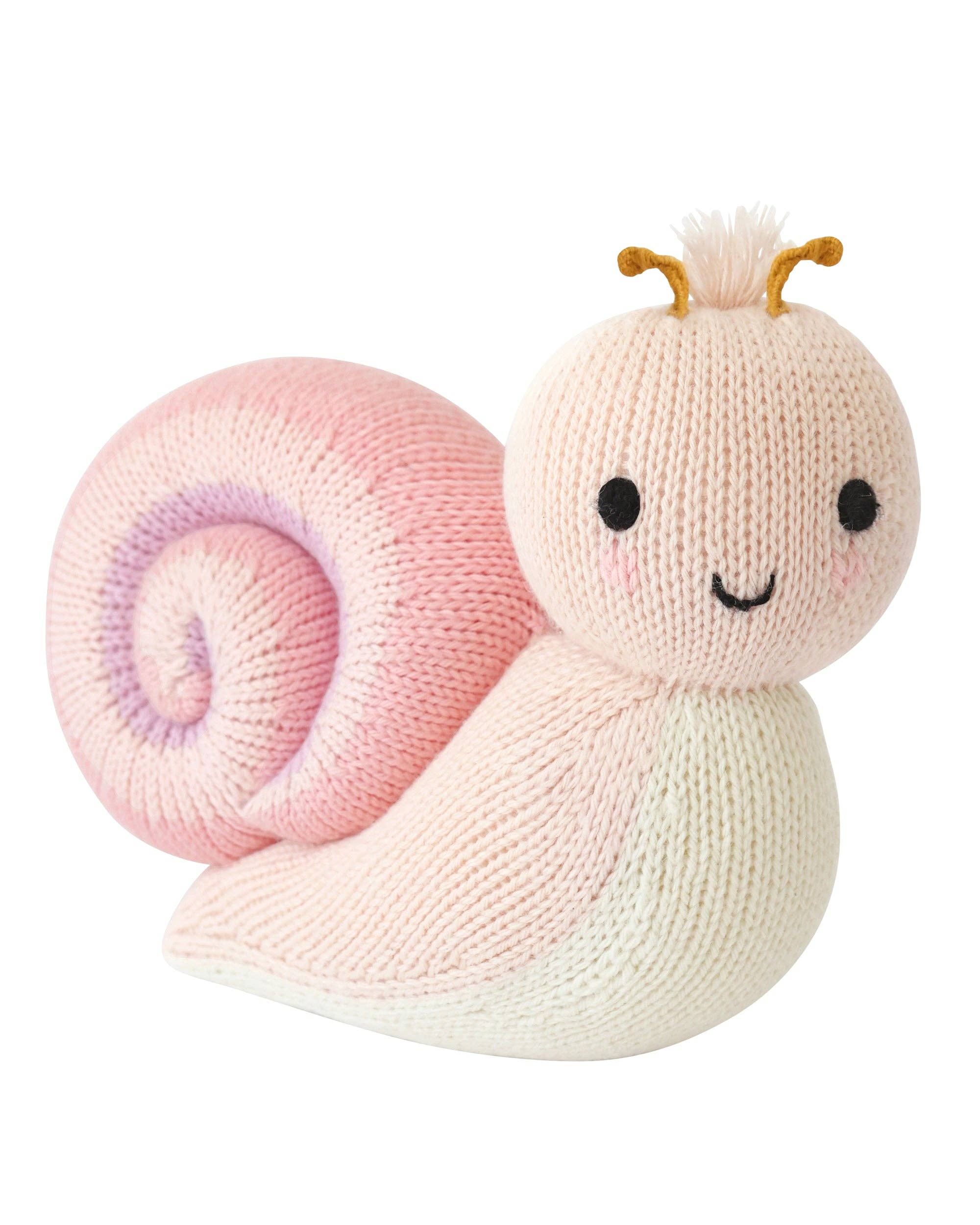 Knitted toy snail with pink shell and white body on a white background