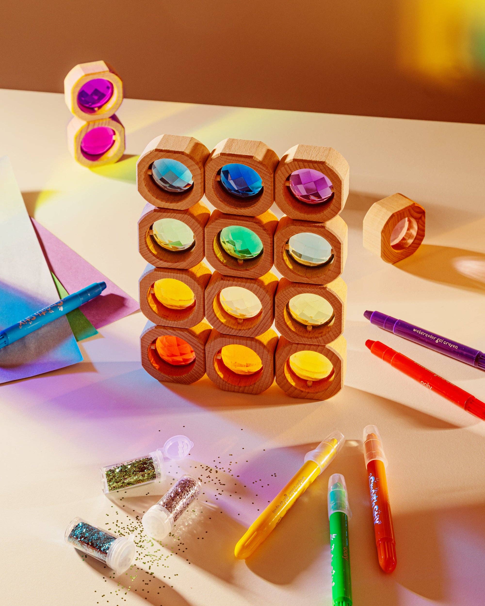 Colorful wooden blocks with markers on a light surface