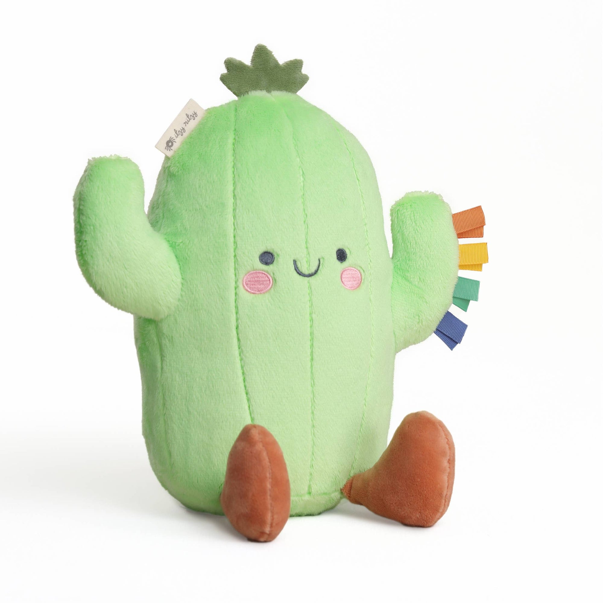 Plush cactus toy with a happy face on a white background