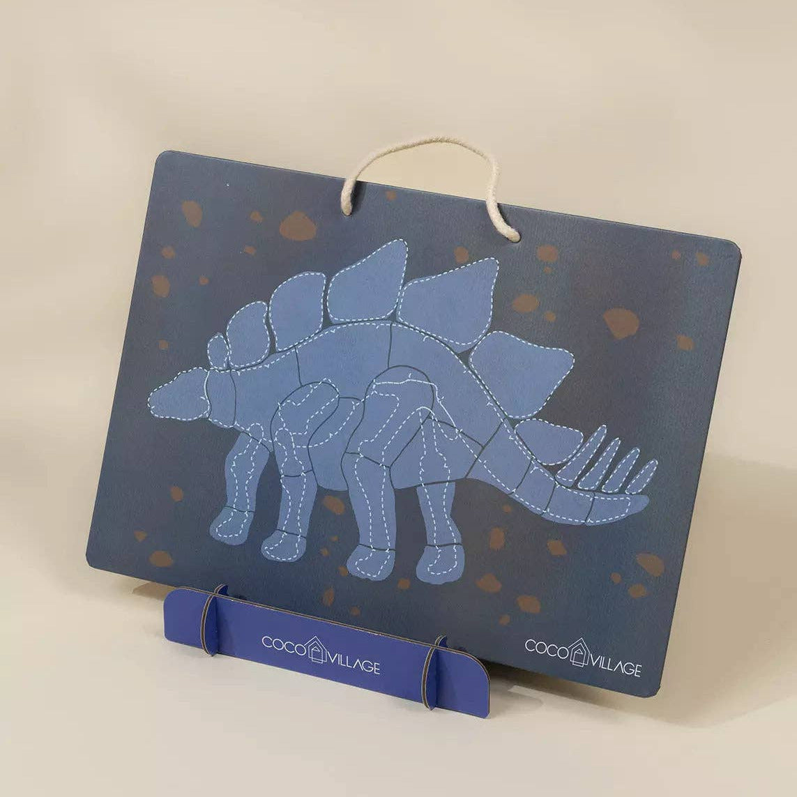 Blue dinosaur skeleton on a dark blue card with 'Coco Village' branding.