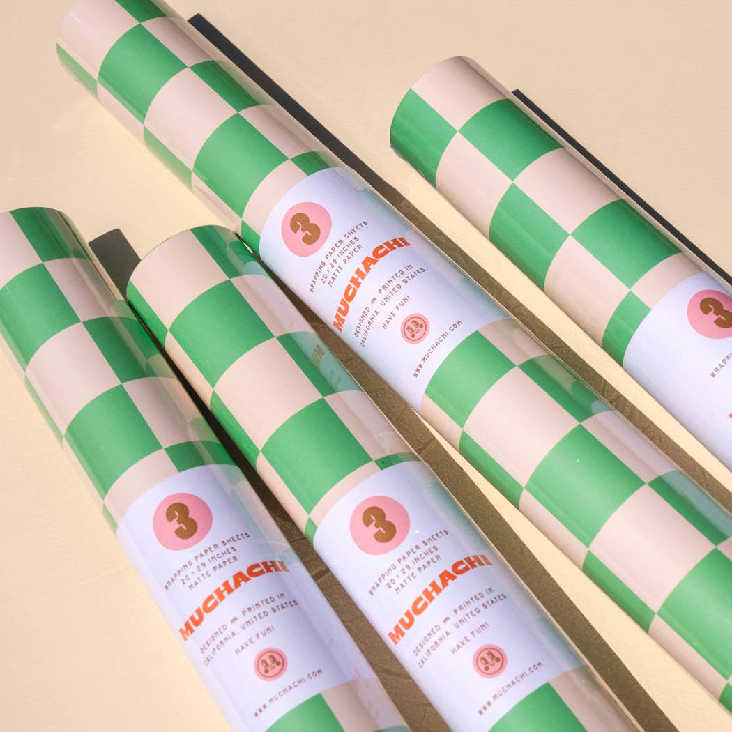Two rolls of green and white checkered paper with 'Muchachos' branding on a beige background.