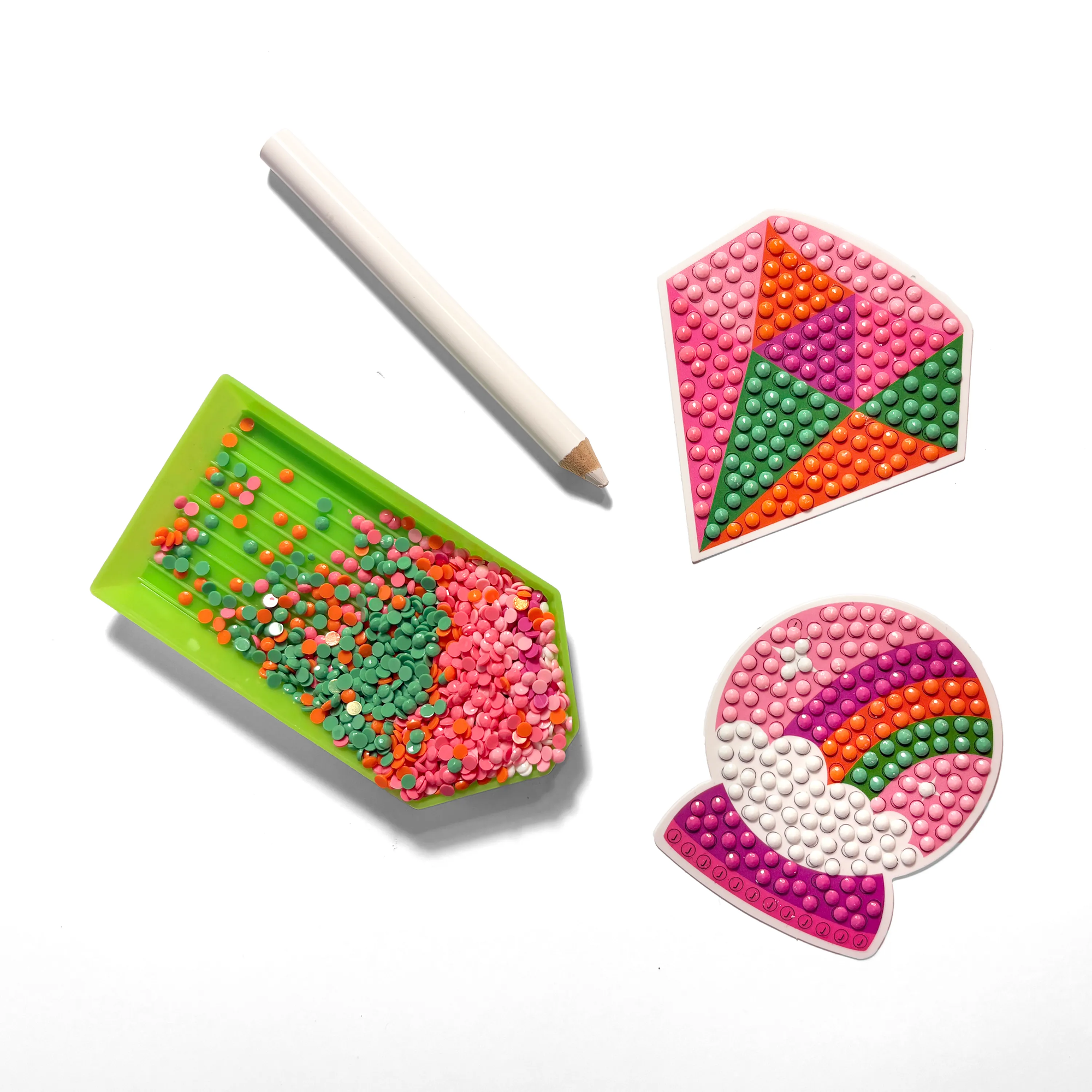 Colorful bead boards with a pen on a white background